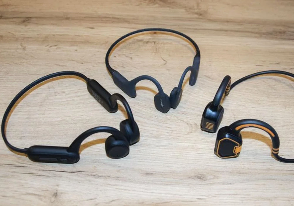 Three black bone conduction headphones put together for comparison